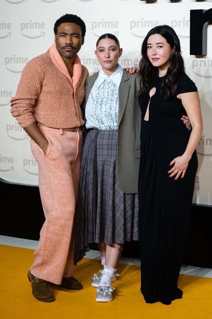 Scriitoarea Francesca Sloane (centru) participă la premiera din Marea Britanie a filmului „Mr & Mrs Smith” – împreună cu vedetele Donald Glover și Maya Erskine – pe 17 ianuarie 2024, purtând o pereche de crocs împodobiți cu perle de la designerul de modă Simone Rocha, ca parte a filmului. o colaborare cu brandul