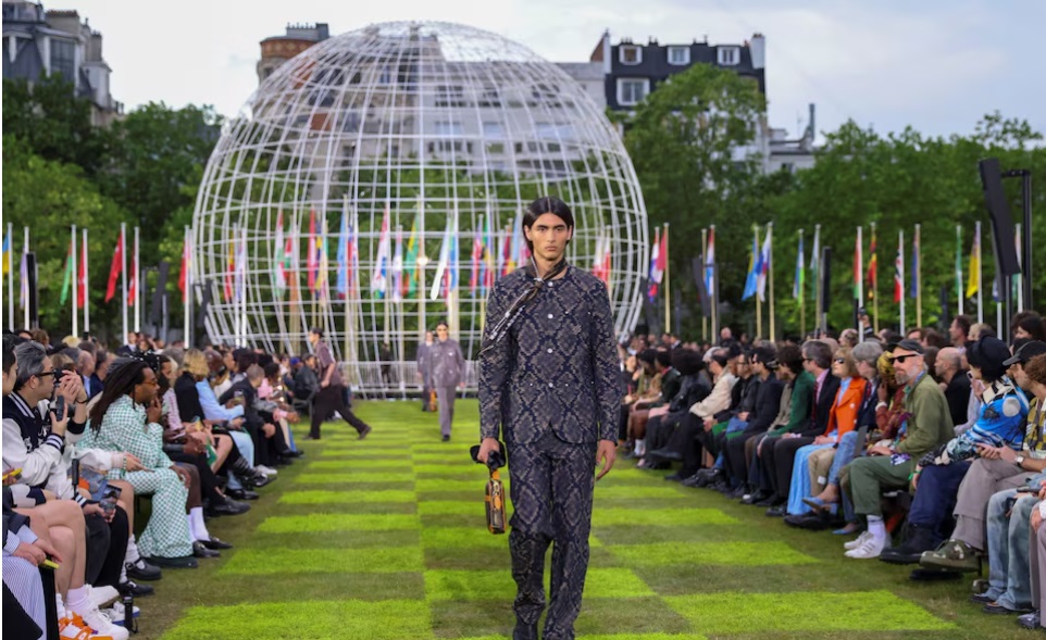 Un model prezintă o creație concepută de muzicianul Pharrell Williams pentru casa de modă Louis Vuitton, ca parte a spectacolului său de colecție de articole de îmbrăcăminte pentru bărbați