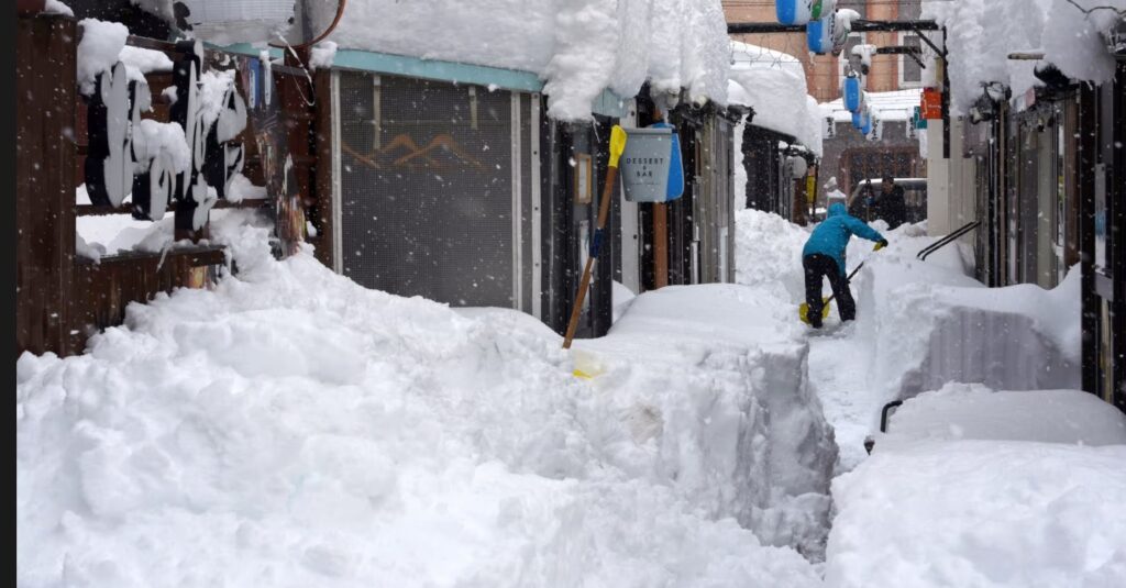 Un bărbat sapă în zăpadă după căderi abundente în Obihiro, Hokkaido, nordul Japoniei (Foto: Jiji Press/EPA)